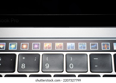 Kiev, Ukraine - August 9, 2022: Emoji Pictures With City Night Views On Touch Bar Apple Macbook Pro Closeup