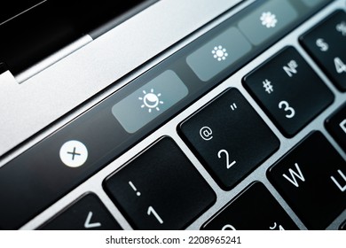 Kiev, Ukraine - August 9,2022: Screen Backlight Mode Change Button On Touch Bar Apple Macbook Pro Close Up. True Tone, Night And Day Mode Of The Laptop Monitor