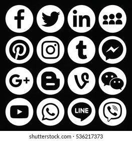 Kiev, Ukraine - December 05, 2016: Collection of popular round white social media icons printed on black paper: Facebook, Twitter, Google Plus, Instagram, Pinterest, LinkedIn, Tumblr and others