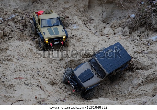 Kiev, Ukraine - December, 2018: radio-controlled car
and road situation illustration help, car pulls with a cable helps
to go, rc car.