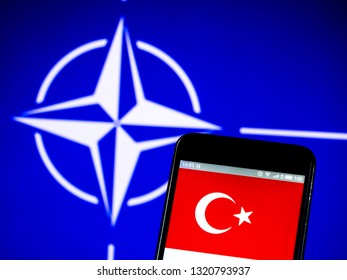 KIEV, UKRAINE - Feb 23, 2019: Turkey Flag On The Phone Display On The Background Of The NATO Flag