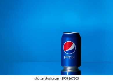 Kiev, Ukraine - February 14, 2021: 0.25 liter tin can of the world famous American drink Pepsi stands against a blue background.