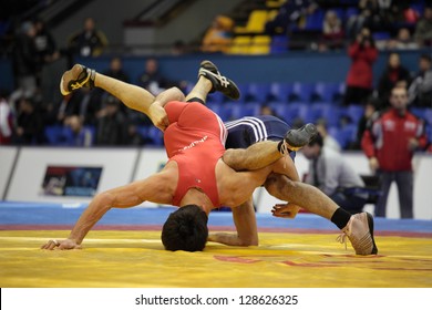 KIEV, UKRAINE - FEBRUARY 16: Match Between Iakobishvili, Georgia, Red And Kabisov, Russia During International Freestyle Wrestling And Female Wrestling Tournament In Kiev, Ukraine On February 16, 2013