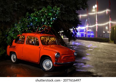 KIEV, UKRAINE - January 10, 2021:  Red Retro Car Zaporozhets 965 With Decorated Christmas Tree On Its Roof. Christmas Street Decoration. Editorial