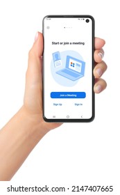 Kiev, Ukraine - January 20, 2022: Hand Holds Mobile Phone With Zoom Meetings App On Its Screen. Zoom Meetings Is A Proprietary Videotelephony Software Program