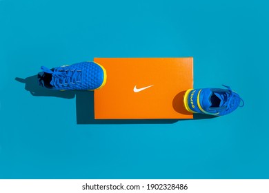 Kiev, Ukraine - January 26, 2021: Nike Sports Shoes For Men. Blue Sneakers Near The Orange Box. Creative Composition