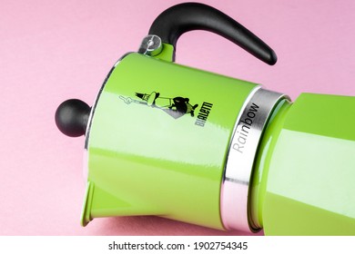 
Kiev, Ukraine - January 26, 2021: BIALETTI metal coffee maker in green color isolated, geyser coffee maker on pink background