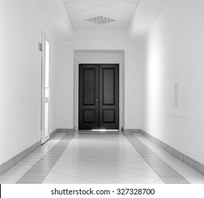 Kiev, Ukraine - July 6, 2015: White Hallway With Marble Floor And Brown Door In Hospital Black And White