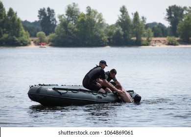 KIEV, UKRAINE - July 7, 2015: Rescuers Rush To Help A Sinking Person During A Training Session To Rescue Drowning People In Kiev, Ukraine.