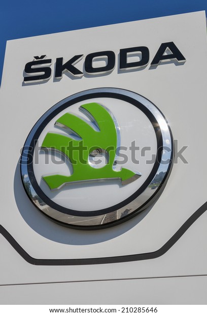 KIEV, UKRAINE - JUNE 12, 2014: Skoda Czech car\
manufacturer logo closeup outdoor in front of official dealer Praha\
Auto, established 2002. Skoda is automobile manufacturer based in\
Czech Republic.