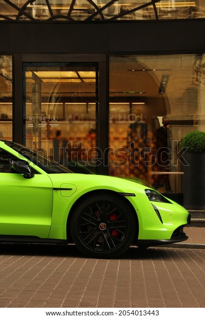 Kiev, Ukraine - June 19, 2021: Matte Porsche\
Taycan Turbo S lime color in the\
city