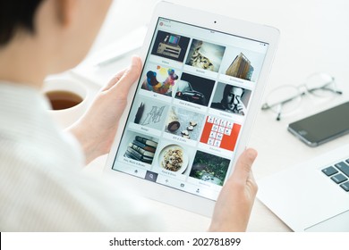 KIEV, UKRAINE - JUNE 27, 2014: Woman Looking On Pinterest Application Boards On Modern White Apple IPad Air, Which Is Designed And Developed By Apple Inc. And Was Released On November 1, 2013.