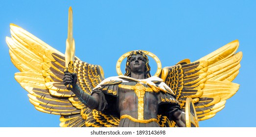 Kiev, Ukraine - March 04, 2018: View of the top of the snow-covered statue of Archangel Michael, the symbol of the city.