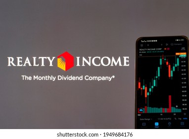 Kiev, Ukraine, March 29, 2021. In This Photo Illustration The Stock Market Information Of Realty Income Corporation Seen Displayed On A Smartphone With The Realty Income Corporation Logo In Background