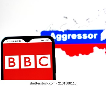 Kiev, Ukraine - March 3, 2022: In this photo illustration, the BBC logo is displayed on a smartphone screen with a flag of Russia in the form of a map of the country with the inscription Aggressor 