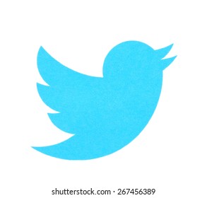KIEV, UKRAINE - MARCH 31, 2015: Twitter logo printed on paper and placed on white background. Twitter is a social networking and microblogging service.