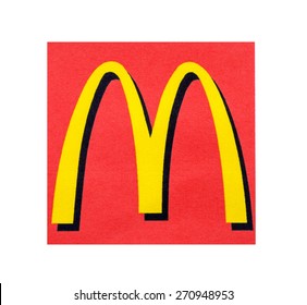 KIEV, UKRAINE - MARCH 31, 2015: McDonal's Logo printed on paper and placed on white background. The McDonald's Corporation is the world's largest chain of hamburger fast food restaurants.
