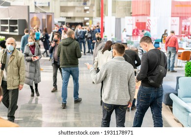 Kiev, Ukraine March 5 2021. Furniture exhibition during a pandemic. international furnishing accessories exhibition. People wearing medical masks during a pandemic. Exhibition and social distance
