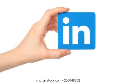 KIEV, UKRAINE - MARCH 7, 2015: Hand Holds Linkedin Logo Sign Printed On Paper On White Background. Linkedin Is A Business Social Networking Service.