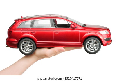 Kiev, Ukraine - May 15, 2019: Woman Hand Holding A Big Red Car Toy Audi On White Background.