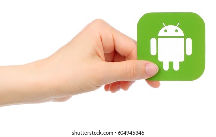 Kiev, Ukraine - May 17, 2016: Hand Holds Android Icon Printed On Paper, Isolated On White Background