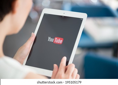 KIEV, UKRAINE - MAY 21, 2014: Woman Holding A Brand New Apple IPad Air With YouTube Logo On A Screen. YouTube Is The World's Most Popular Online Video-sharing Website That Founded In February 14, 2005