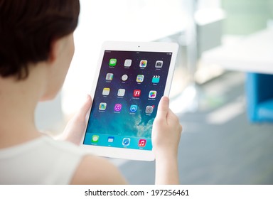 KIEV, UKRAINE - MAY 21, 2014: Woman Holding Brand New White Apple IPad Air, The Most Advanced Digital Tablet In Part Of The IPad Line. Developed By Apple Inc. And Was Released On November 1, 2013.