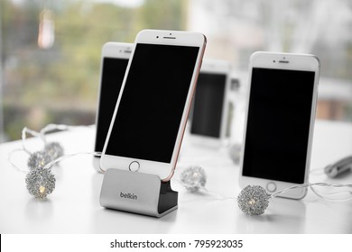 KIEV, UKRAINE - NOVEMBER 08, 2017: Modern iPhone 8 Plus Gold and Belkin stand on table against blurred background