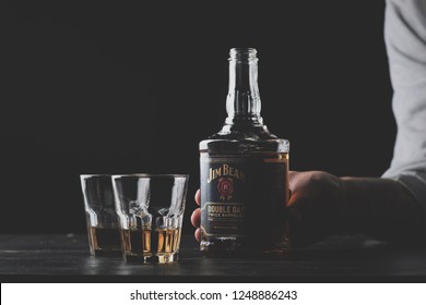 Kiev, Ukraine - November 23, 2018: Bottle and glass Jim Beam is one of best selling brands of bourbon in the world, produced by Beam Inc. in Clermont, Kentucky