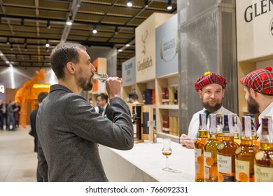 KIEV, UKRAINE - NOVEMBER 25, 2017:   man visits Glenlivet Single Malt Scotch Whisky Highland distillery booth at 3rd Ukrainian Whisky Dram Festival in Parkovy Exhibition Center.