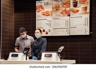 Kiev, Ukraine, October 16, 2021, McDonald's Staff Waiting For Their Customers At Cashier Desk. Workers Are At Protective Medical Masks And Blue Gloves.