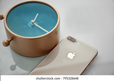 KIEV, UKRAINE - OCTOBER 25, 2017: Gold IPhone 8 Plus With Alarm Clock On Table