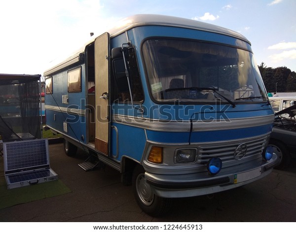 Kiev, Ukraine, on September 30, 2018.\
Exhibition of retro cars. Retro camper Mercedes Benz with an open\
door, next to it is a folding solar\
panel.