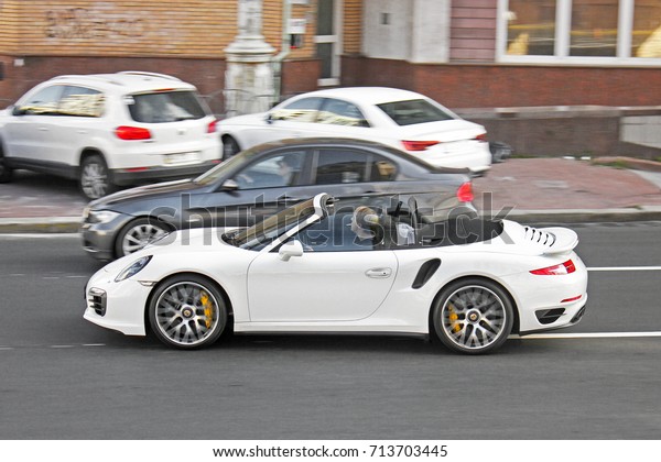 Kiev, Ukraine -\
September 2, 2017: White convertible in motion. Porsche 911 Turbo S\
Cabriolet (991) in motion