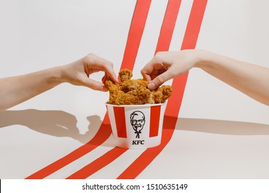 Kiev, Ukraine - September 21, 2019: Hands Hold KFC Fried Chicken 