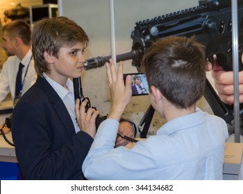 Kiev, Ukraine - September 22, 2015: Boy posing with a gun at the specialized exhibition "Arms and Security - 2015"
