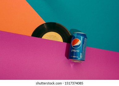 Kiev, Ukraine - September 29, 2019: can of Pepsi and music disc. Retro style. Top view