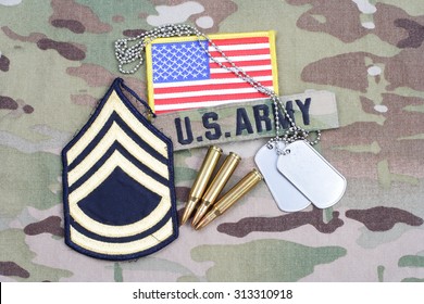 KIEV, UKRAINE - September 5, 2015. US ARMY Sergeant First Class Rank Patch,  Flag Patch, With Dog Tag With 5.56 Mm Rounds On Camouflage Uniform