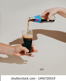 Kiev, Ukraine - September 5, 2019: a hand pours Pepsi into a glass