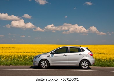 KIEV, UKRAINE-JULY 4, 2016: Kia Rio Parked On The Road Near The Field.  Automotive Photography. Space For Text. Nature Background With Car. Landscape With Car. Spring Field And Car.