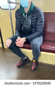 Kiev Ukraine-May 2021: A Man In A Mask And Ripped Jeans Rides In A Subway Car To Work. 