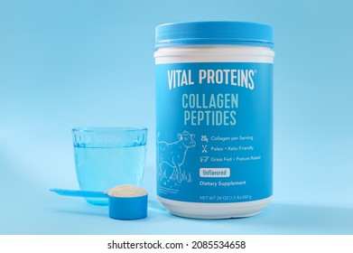 KIEV, UKRAINE-NOVEMBER 10, 2021: Collagen Peptides Powder Jar With A Measuring Spoon And A Glass Of Water. Famous Brand Vital Proteins. Collagen From The Skins Of Grass-fed Pasture Cows, Unflavored.