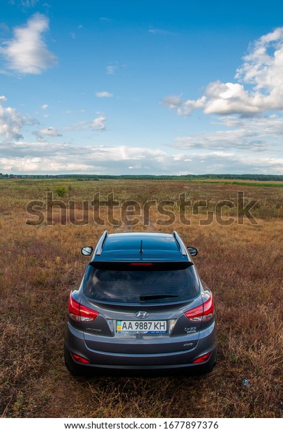 KIEV, UKRAINE-OCTOBER 1,\
2017: SUV Hyundai ix35 parked on the field on a cloudy day.\
Off-road concepte. Space for text. Nature background with car.\
Landscape with car. 