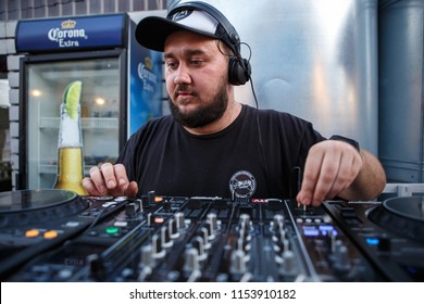 KIEV-10 JULY,2018: DJ Panchez In Headphones Plays Musical Set In Party Bar.Hip Hop Disc Jockey Mix Music Tracks With Pioneer Turntable & Sound Mixer In Nightclub Outdoor.Disco Club Entertainment Event