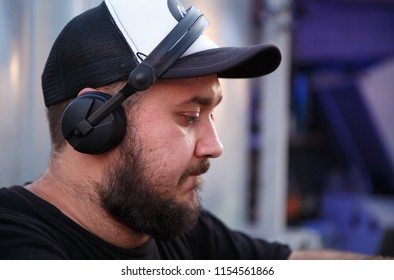 KIEV-10 JULY,2018: DJ Panchez In Headphones Plays Musical Set In Party Bar.Hip Hop Disc Jockey Mix Music Tracks With Pioneer Turntable & Sound Mixer In Nightclub Outdoor.Disco Club Entertainment Event