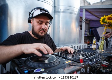 KIEV-10 JULY,2018: DJ Panchez Plays Musical Set In Party Bar.Hip Hop Disc Jockey Mix Music Tracks With Pioneer CDJ Turntables And DJM Sound Mixer In Summer Bar Outdoor.Disco Club Entertainment Event