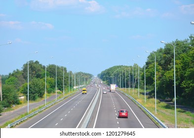 Kiev-Chop Highway in the afternoon with cars, two lanes in each direction, view into the distance.
