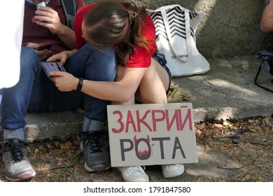 Kiev/Ukraine - 08.06.2020: Young Woman Protester With Protest Banner On Her Feet Seets On The Street And Hugs Leg Of Boyfriend. Reportage Editorial Photo.