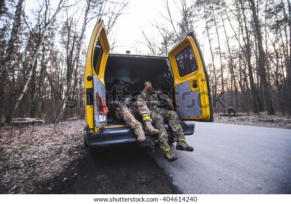 KIEV,UKRAINE - March\
26:Soldiers with weapon in truck with open doors on forest road\
during military training \