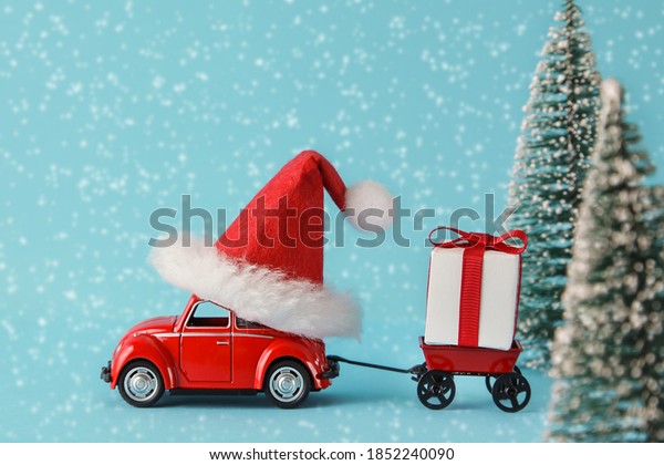 Kiev,Ukraine, October,30,2020: retro toy\
car with trailer delivering Christmas or New Year gifts.\
